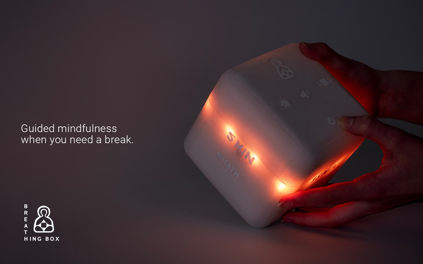 Product image of the Breathing Box. With logo and slogan: Guided mindfulness when you need a break